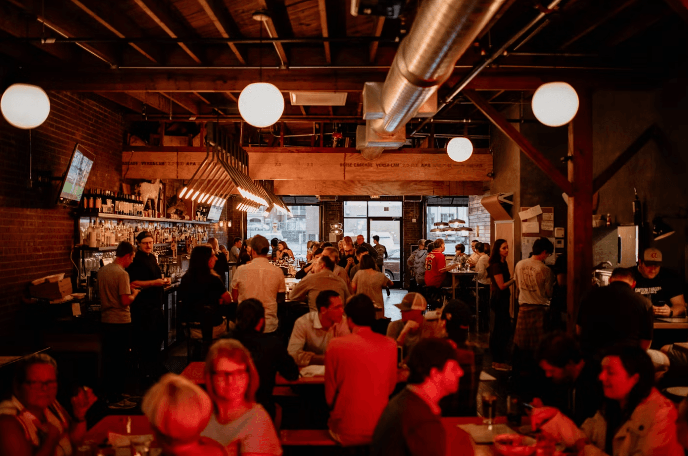 Warm independent restaurant interior with string lights and bar
